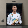 Framed poster of Cristiano Ronaldo holding the golden boot trophy in a Real Madrid kit.