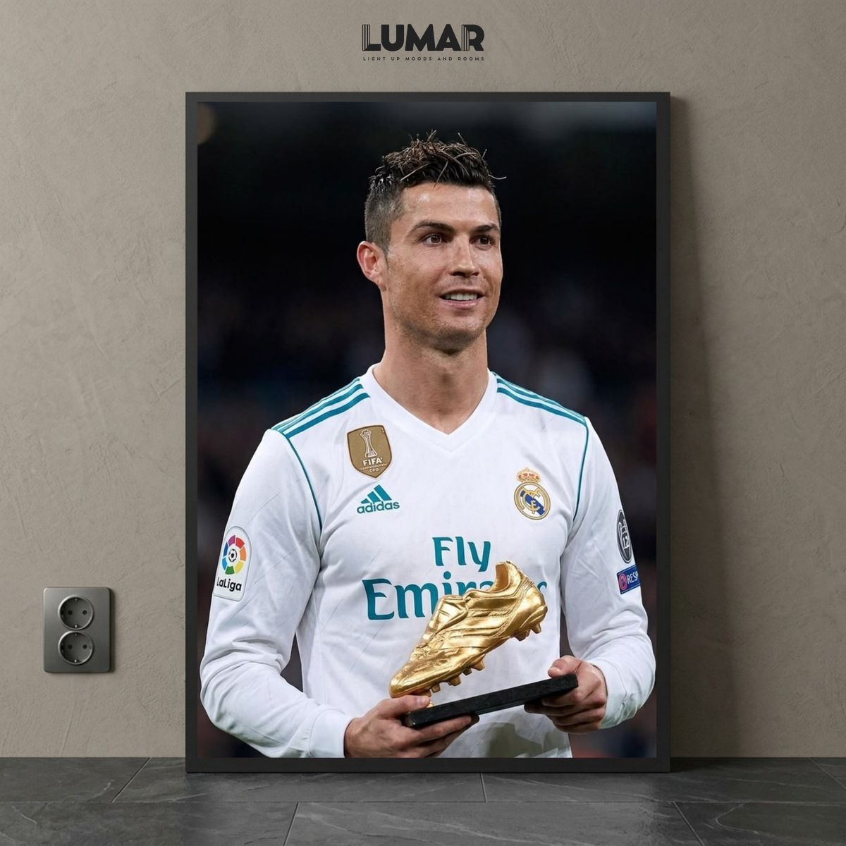 Framed poster of Cristiano Ronaldo holding the golden boot trophy in a Real Madrid kit.