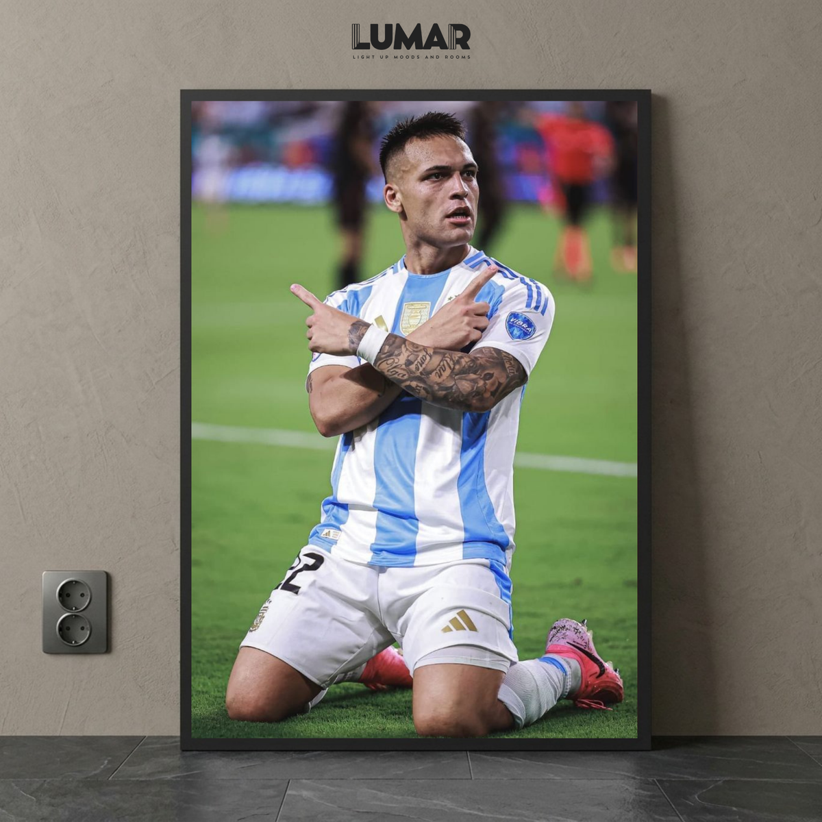 Framed poster of Lautaro Martinez kneeling on the field in an Argentina national team kit while celebrating.