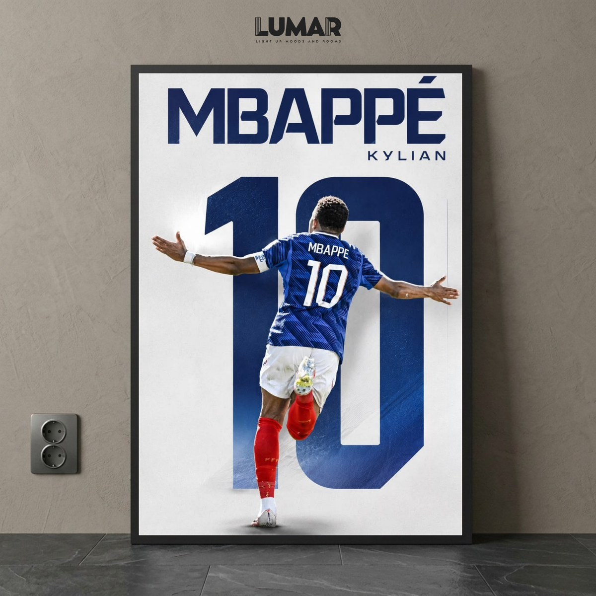 Framed wall art poster featuring Kylian Mbappé in his number 10 jersey celebrating on a white and blue graphic background.