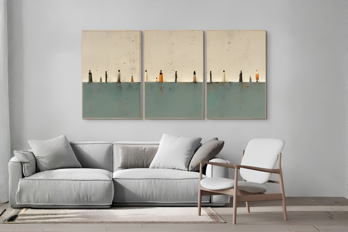 Modern living room with a gray sofa, white chair, and three framed artworks on the wall.